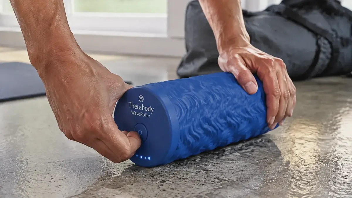 Close-up of the Therabody WaveRoller vibrating foam roller with control button visible