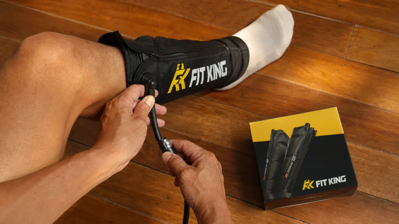 Person removing FIT KING compression sleeves after a 20-minute session, showing the air hose disconnect