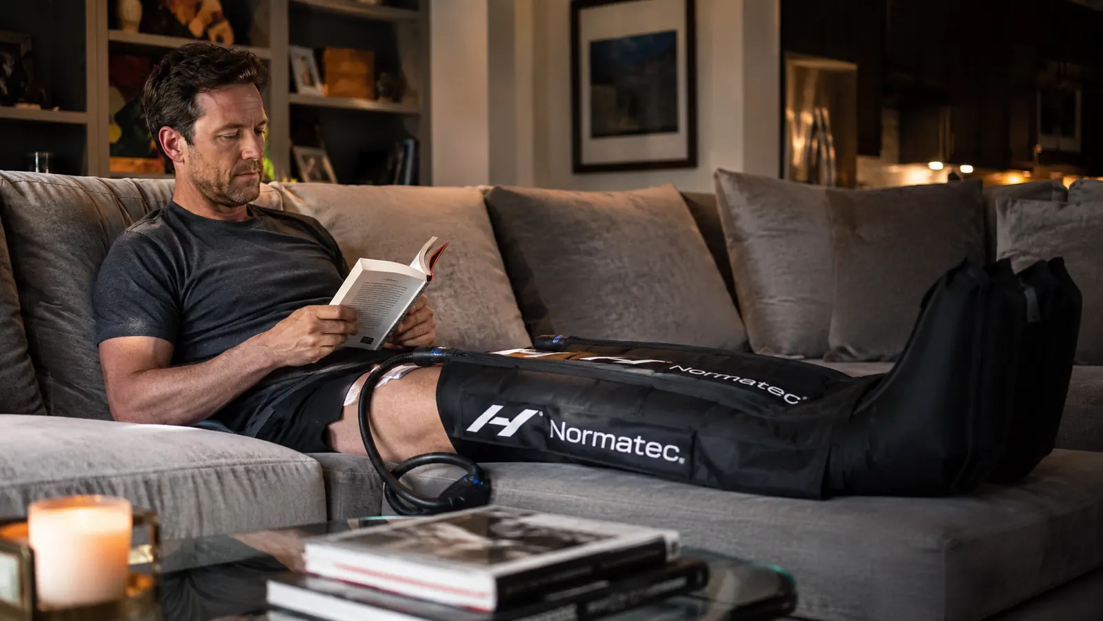 Active adult relaxing with legs elevated in compression boots after a long training session