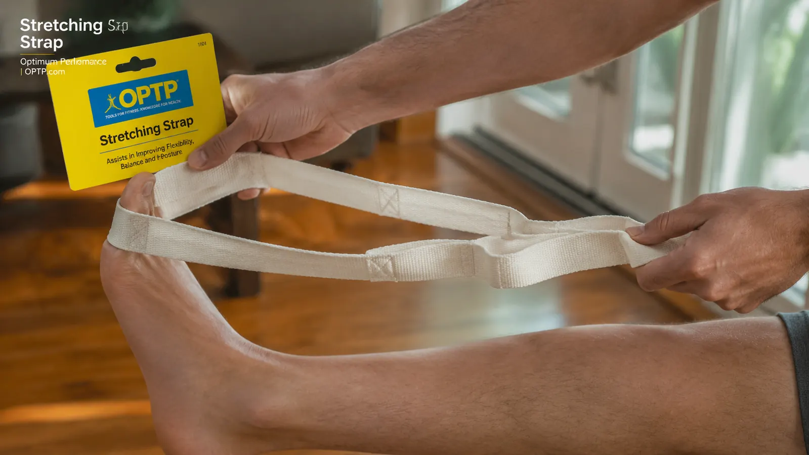 Close-up of a hand holding the OPTP Stretch Out Strap, showing the multiple loops along its length