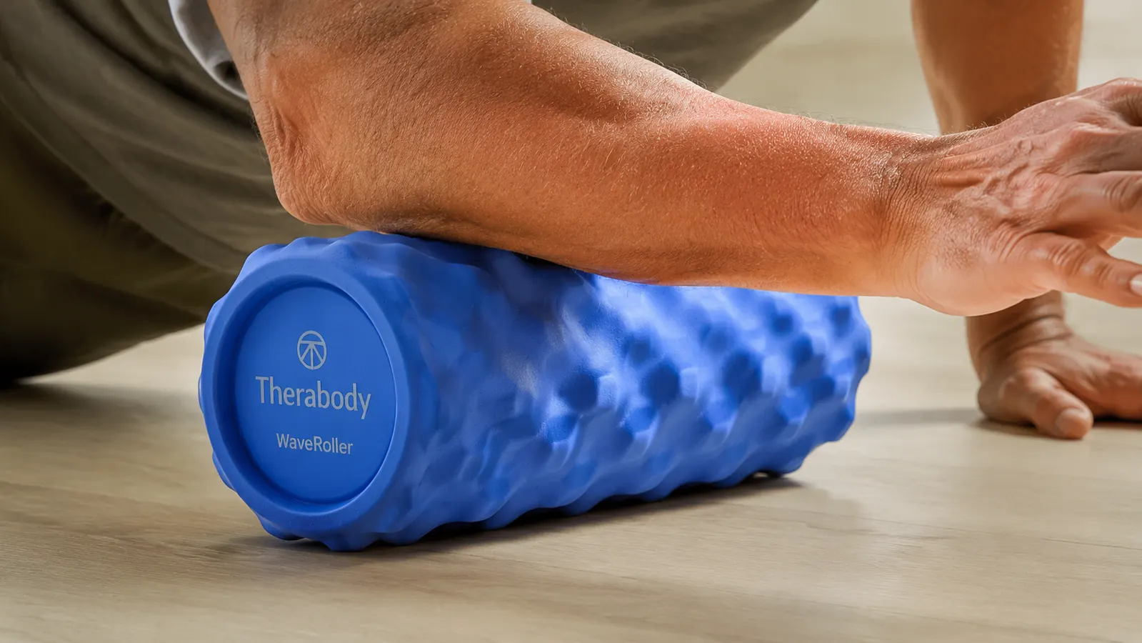 Close-up of vibrating foam roller ridges on a wooden surface